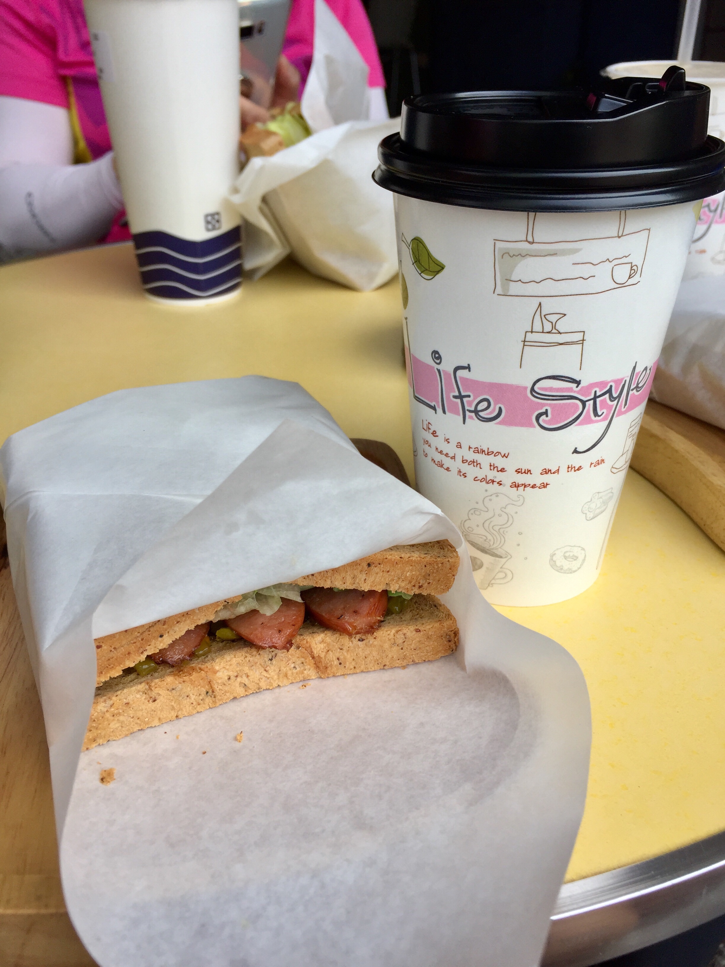 Cup of freshly brewed coffee & sauage sandwich to start the day