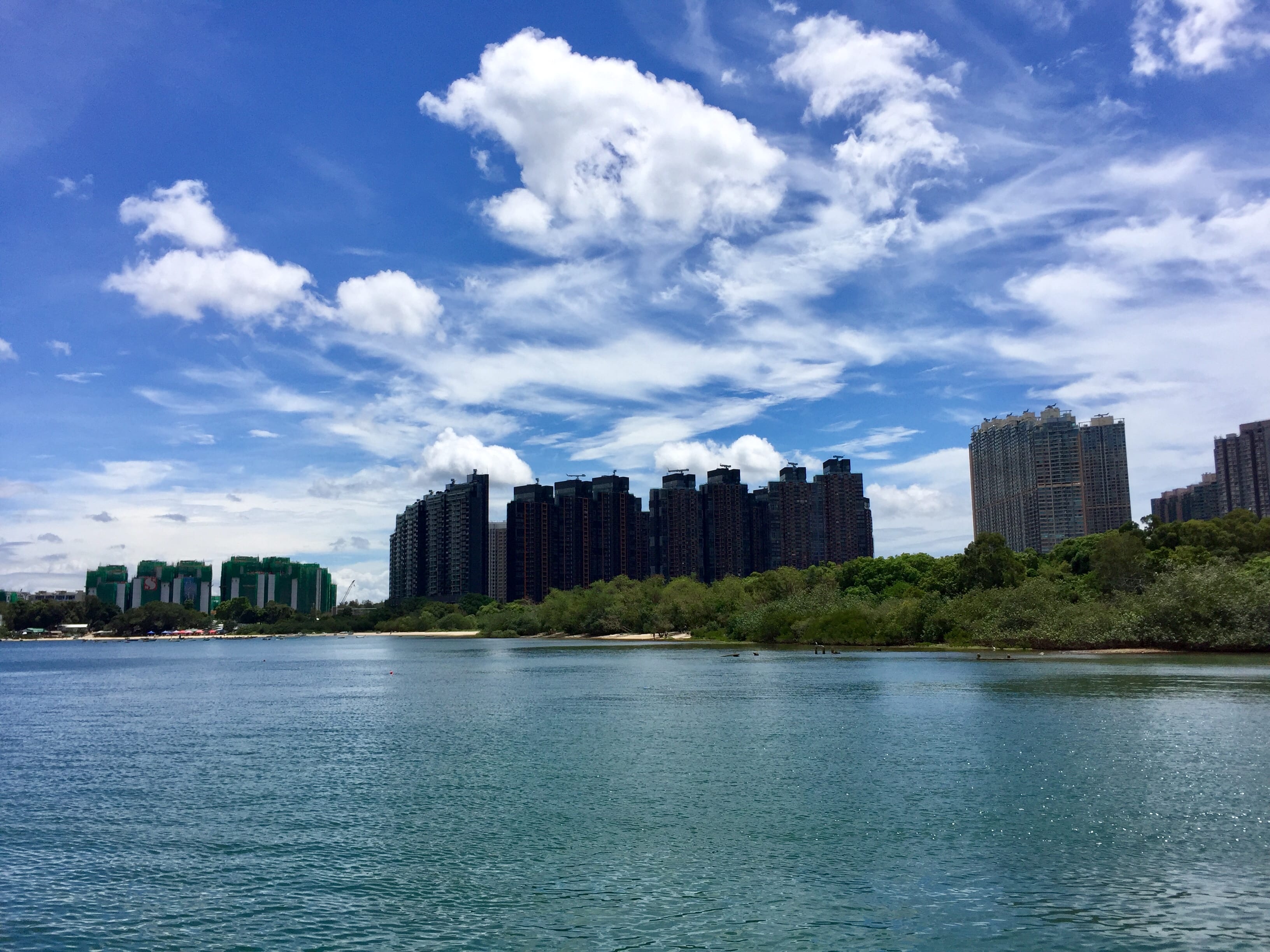 Wu Kai Sha Beach with high rise luxury apartments in the background