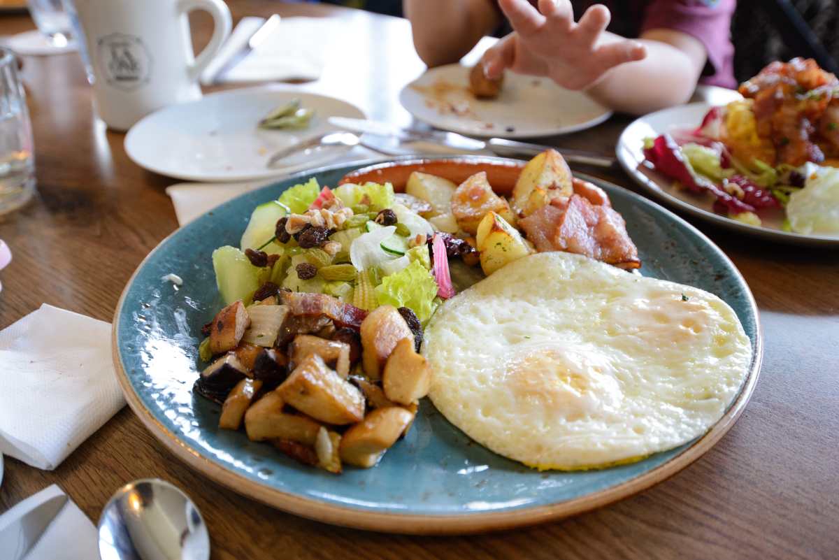 Sunny Eggs with Potato, Mushroom, Bacon, Sausage, Salad and Bread