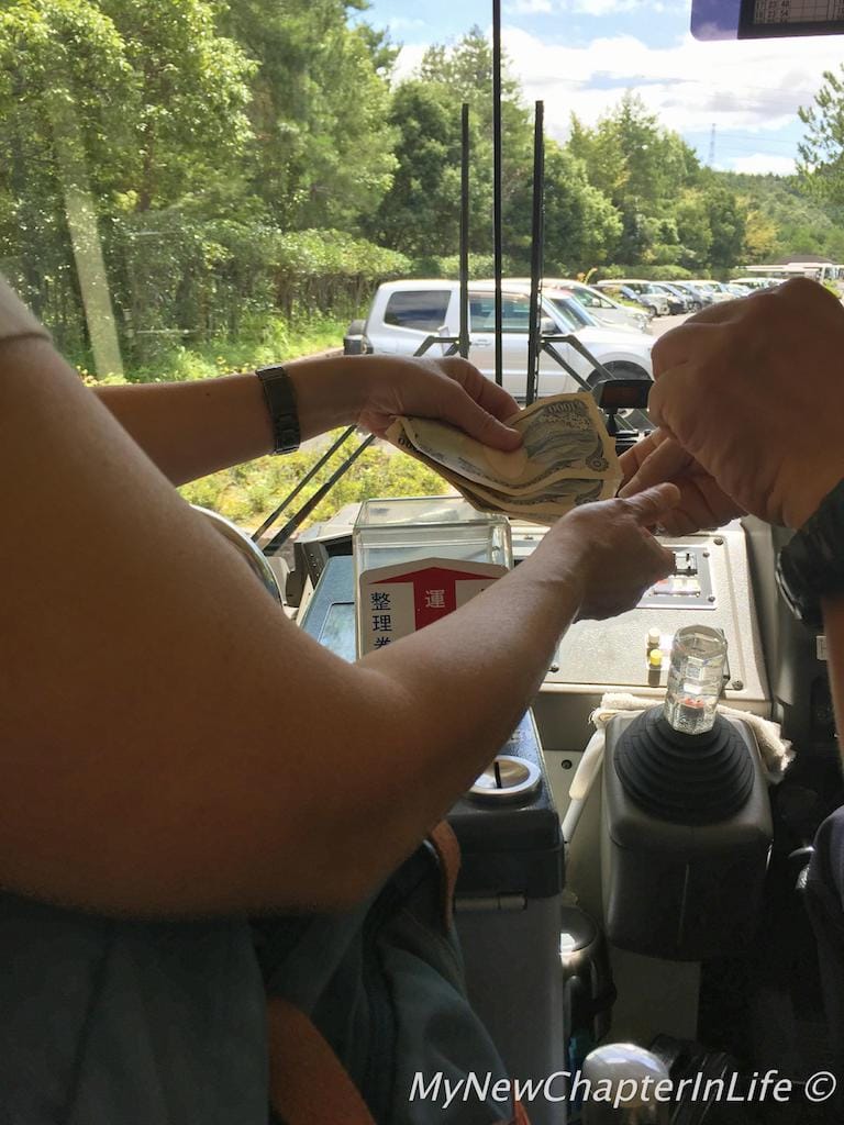 Paying bus fare at the end of the bus journey